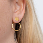 This cyclical earring with jacket is crafted from brass, a strong, durable metal that will stand up to wear over time. With its sleek design and rustic feel, it's an ideal choice for everyday wear. The earring adds a touch of simple sophistication to any outfit. Wear with or without the jacket. Pair with the Cyclical Choker Necklace to complete the look.